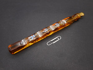 An amber glass scent bottle with enamelling.  Lacrymosal / Tear catcher