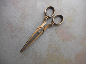 A tiny pair of doll's silver scissors. c1900