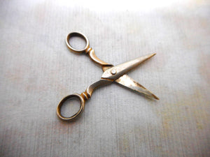 A tiny pair of doll's silver scissors. c1900