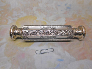 An engraved white metal double ended scent bottle. c1880