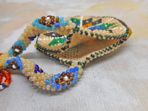 A colourful beadwork 'watch pocket'. c1910