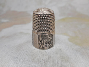 An engraved silver thimble. HM. 1889. Maker HG.