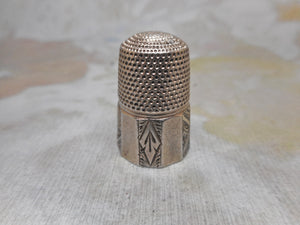 An engraved silver thimble. HM. 1889. Maker HG.