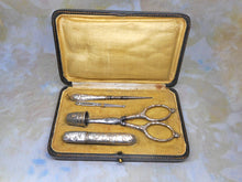 Load image into Gallery viewer, A silver plated set of sewing tools embossed with a pattern of mistletoe. c1900
