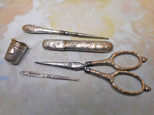 Load image into Gallery viewer, A silver plated set of sewing tools embossed with mistletoe. c1900
