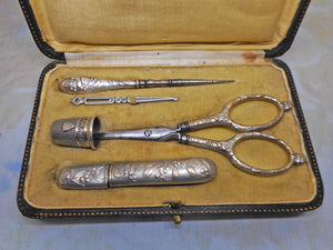 A silver plated set of sewing tools embossed with mistletoe. c1900