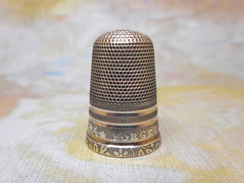 A silver thimble titled Forget Me Not. c1840