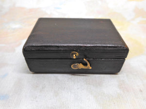 A cased sewing set -a silver tape measure, waxer and emery. c1850