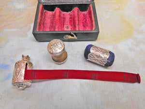 A cased sewing set -a silver tape measure, waxer and emery. c1850
