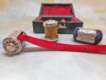 Load image into Gallery viewer, A cased sewing set -a silver tape measure, waxer and emery. c1850
