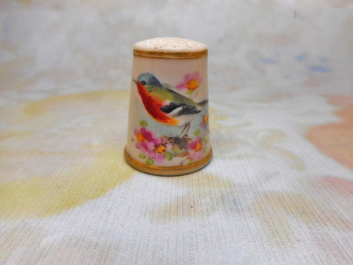 A Worcester porcelain thimble of a finch. Purple  stamp inside. c1913