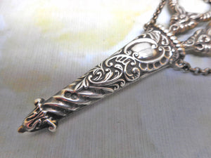 A silver scissor case and scissors from a chatelaine. GU. B'1897.