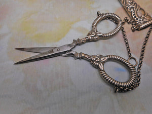 A silver scissor case and scissors from a chatelaine. GU. B'1897.