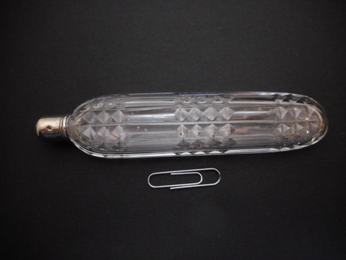 A long glass scent bottle with a silver cap. c1820. English.