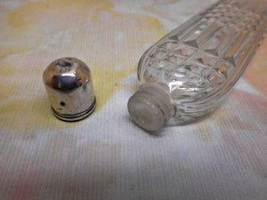 A long, glass scent bottle with a silver cap. c1820. English.