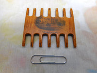 A Mauchline Ware comb shaped thread winder. Abbotsford. c1870