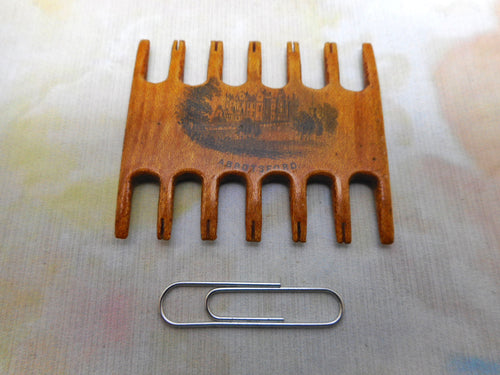 A Mauchline Ware comb shaped thread winder. Abbotsford. c1870