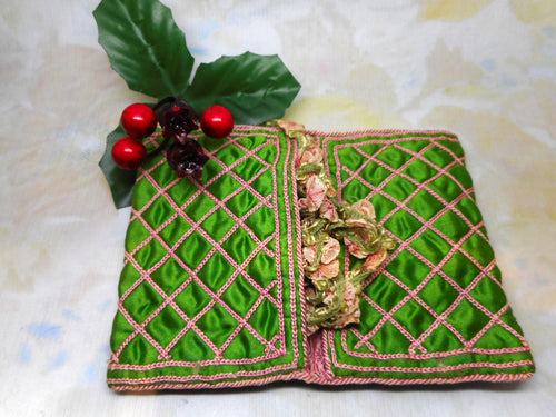 A green silk hussif decorated with chain stitches. c1830