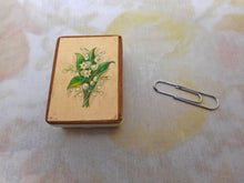 Load image into Gallery viewer, A little cardboard needle box with a print of Lilies of the Valley. c1860
