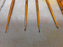 Load image into Gallery viewer, Four gilt steel crochet hooks and the universal handle. c1860.
