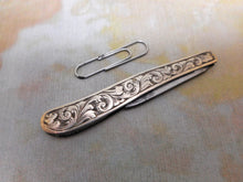 Load image into Gallery viewer, An engraved silver folding seam cutter. c1860
