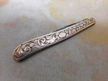 Load image into Gallery viewer, An engraved silver folding seam cutter. c1860
