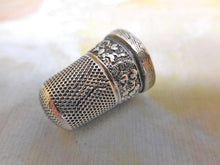 Load image into Gallery viewer, A silver thimble embossed with a band of flowers. c 1835 a/f
