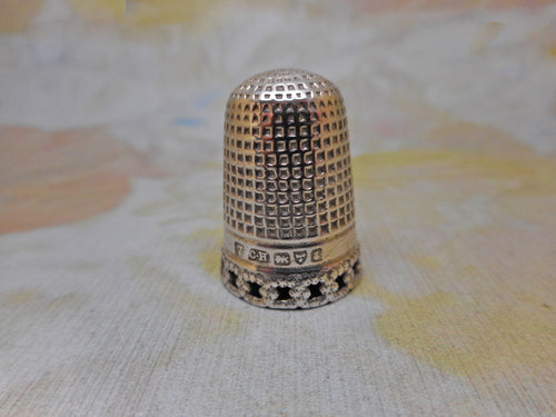 A silver thimble with pierced rim. Charles Horner.