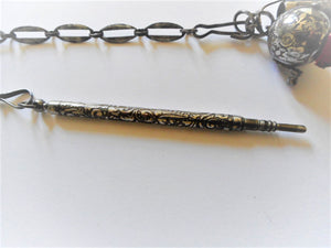 A long, decoratively engraved, cut steel chatelaine with six appendages. c 1850.