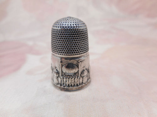 A Victorian silver thimble with an embossed image of Brighton Paviliion. c 1850