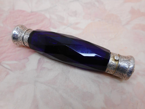 An antique double ended blue glass scent bottle with silver mounts.