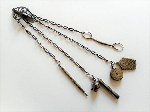 An engraved 19th century cut steel sewing chatelaine.