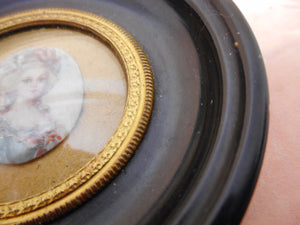 A portrait miniature of a lady in a 19th century frame.