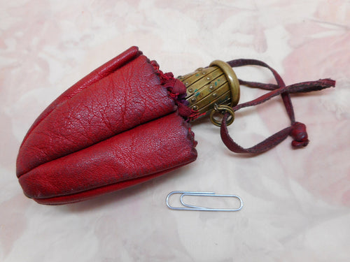 A red leather purse with expanding metal clasp. 19th century.