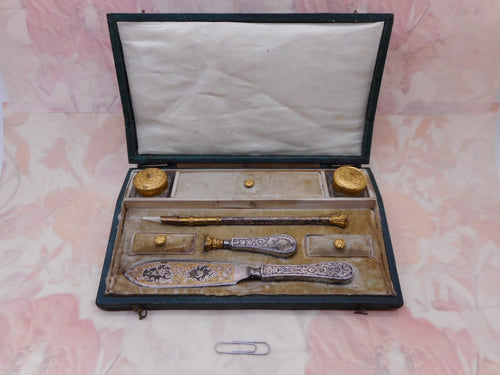 A tooled leather box in the form of a lap desk fitted with writing tools. French c 1840