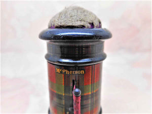 A Tartan Ware thread waxer, tape measure and emery cushion. Clan Mc Pherson.