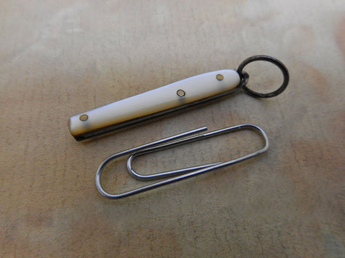 A mini folding knife with pearl sides and a steel blade. c 1900