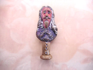 An antique pottery pipe tamper depicting King Charles I