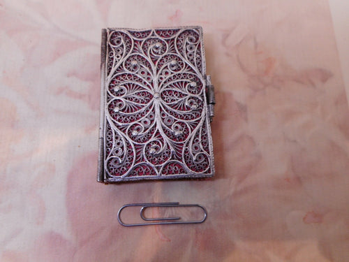 A silver filigree needle case in the form of a book. c1800