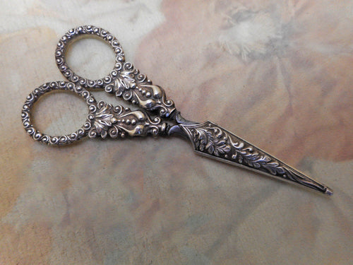 A pair of silver scissors and blade sheath. c 1830