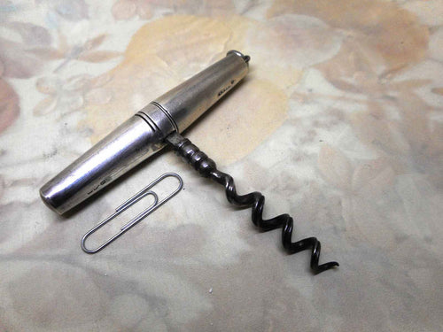 A silver handled, folding pocket corkscrew. 1894