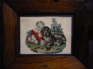 SOLD……..A small framed petit point picture of a child and dog. c 1840