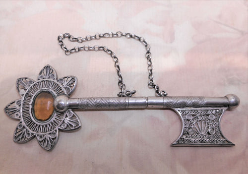 A Dutch silver filigree knitting needle protector in the shape of a key. c 1870