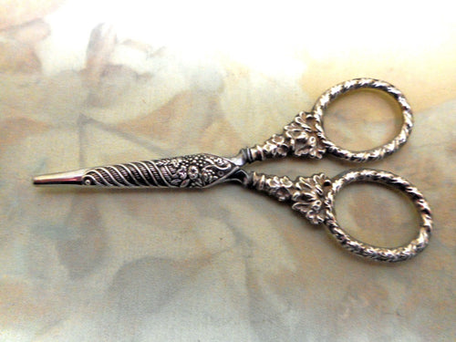 A small pair of silver handled scissors and sheath. c 1835