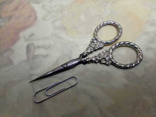 A small pair of silver handled scissors. English c 1830-1840