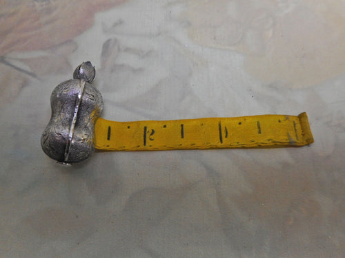 A bright cut engraved silver tape measure. c 1840