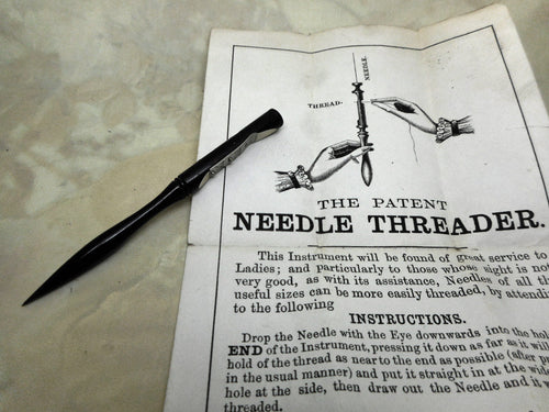 A Joseph Rodgers needle threader with original paper advert. 19thc.