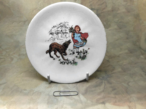 A child's plate with print from Little Red Riding Hood.