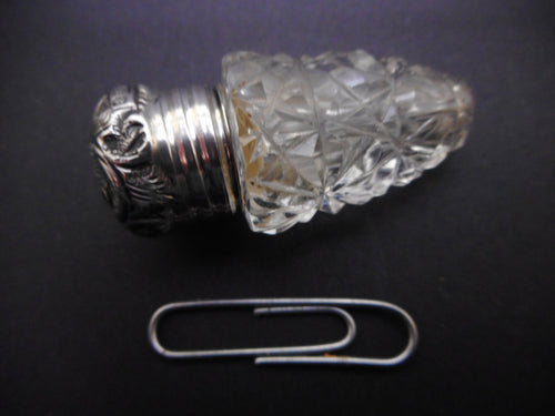 A small cut glass scent bottle with silver lid. HM. 1909.