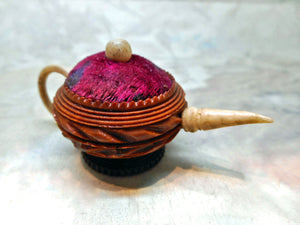 A carved vegetable ivory teapot pin cushion. c 1850